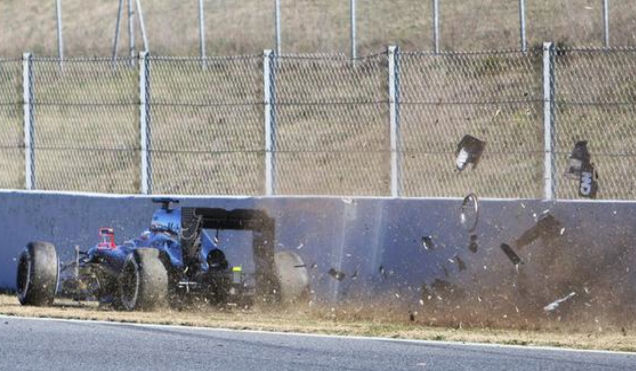 McLaren's Fernando Alonso hits the wall at Barcelona.