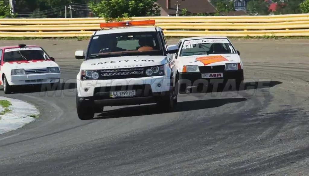 First lap of race with protection auto ahead, all racing vehicles follow. Stock Footage.